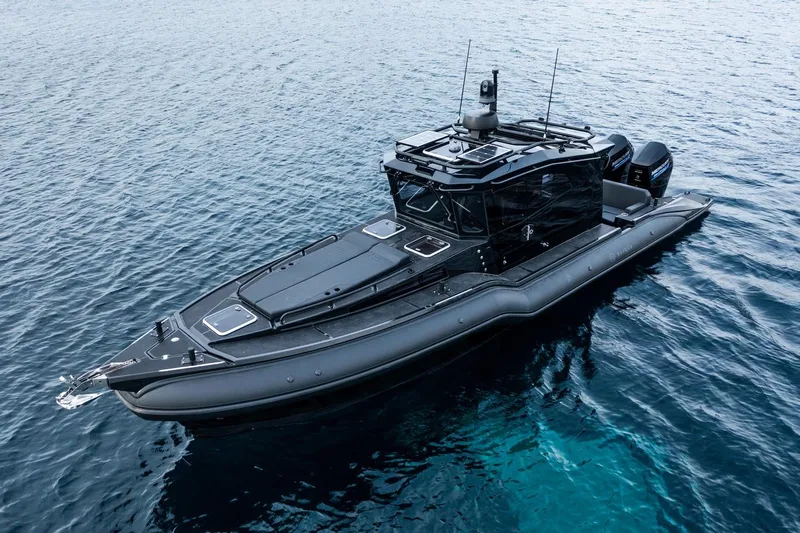  Yacht Photos Pics 2023 Rafnar 1100 C boat on calm blue water, showcasing sleek design and advanced features.