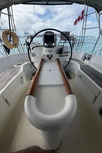 Chivalry Yacht Photos Pics Cockpit of 2000 Beneteau 461 sailboat with steering wheel and ocean view.