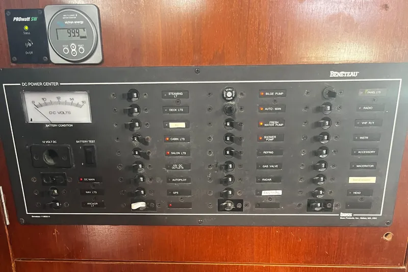 Chivalry Yacht Photos Pics Electrical control panel on a 2000 Beneteau 461 yacht, featuring various switches and gauges.