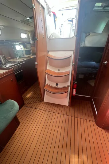 Chivalry Yacht Photos Pics Interior of 2000 Beneteau 461 yacht with wooden flooring and cabin access.