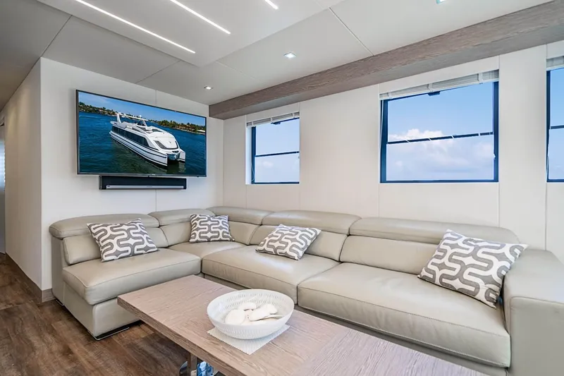 Persistence Yacht Photos Pics Luxurious interior of 2017 Overblue 58 Power Catamaran with leather sofa and flat-screen TV.