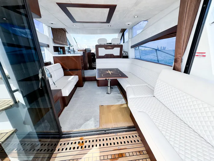  Yacht Photos Pics Luxurious interior of 2016 Galeon 420 Fly yacht with white seating and wooden accents.