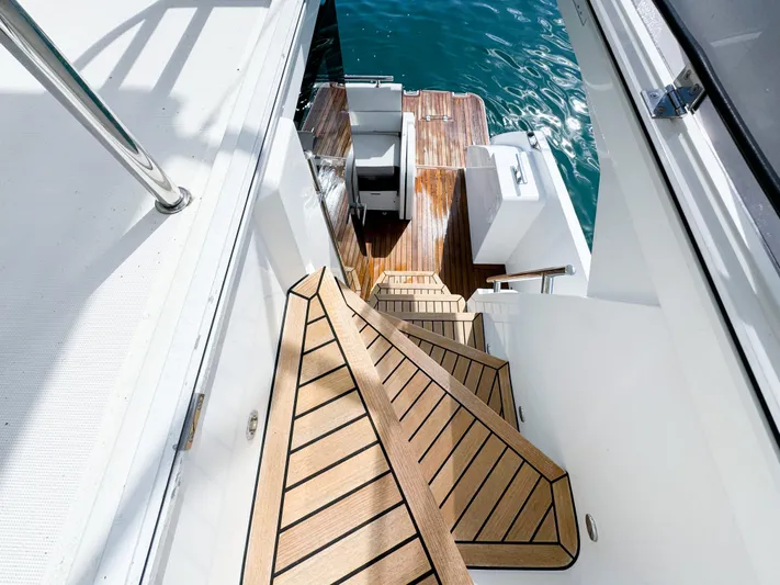  Yacht Photos Pics Staircase on 2016 Galeon 420 Fly yacht leading to wooden deck by the water.