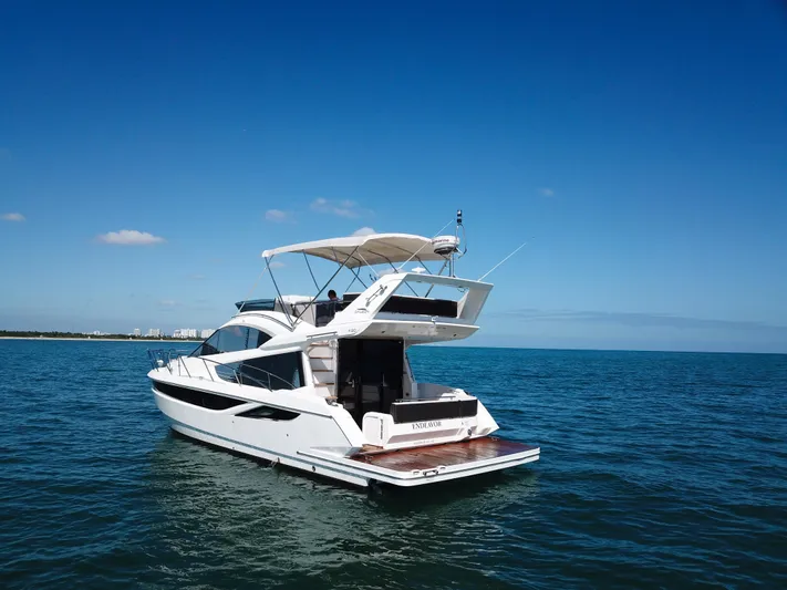  Yacht Photos Pics 2016 Galeon 420 Fly yacht cruising on open water under clear blue skies.