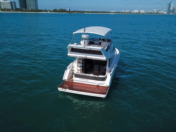  Yacht Photos Pics 2016 Galeon 420 Fly yacht on open water, city skyline in background.