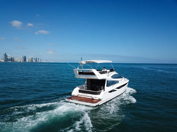  Yacht Photos Pics 2016 Galeon 420 Fly yacht cruising on open sea near city skyline.