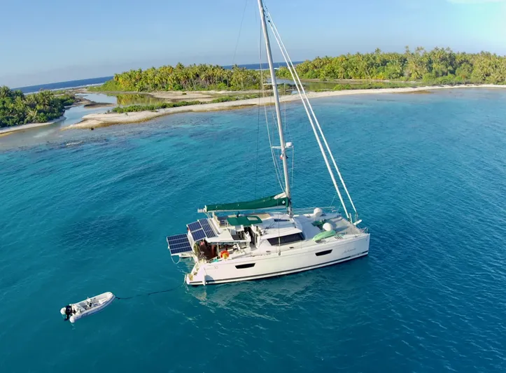 Jajapami Yacht Photos Pics 2017 Fountaine Pajot SABA 50 catamaran anchored near tropical island with clear blue water.