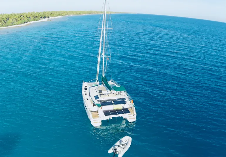 Jajapami Yacht Photos Pics Aerial view of 2017 Fountaine Pajot SABA 50 catamaran with solar panels on blue ocean.