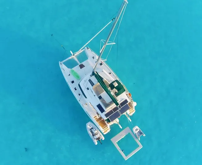 Jajapami Yacht Photos Pics Aerial view of 2017 Fountaine Pajot SABA 50 catamaran on clear turquoise water.