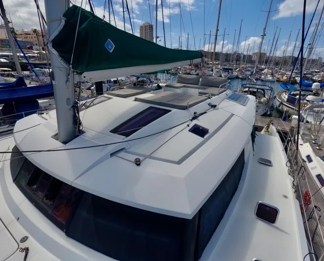 Jajapami Yacht Photos Pics 2017 Fountaine Pajot SABA 50 catamaran docked in a marina, surrounded by sailboats.