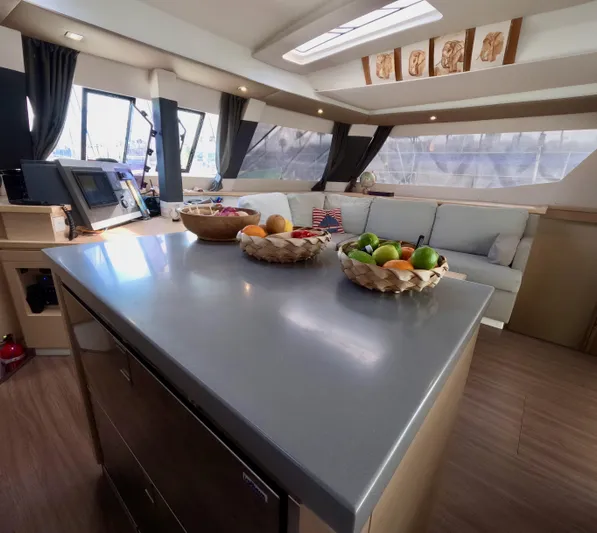 Jajapami Yacht Photos Pics Luxurious interior of 2017 Fountaine Pajot SABA 50 catamaran with modern kitchen and seating area.