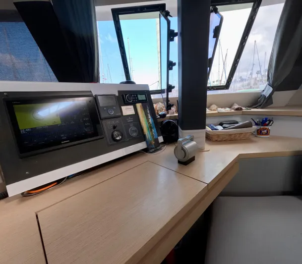 Jajapami Yacht Photos Pics Navigation station inside 2017 Fountaine Pajot SABA 50 catamaran, featuring modern equipment and scenic views.