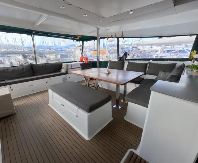 Jajapami Yacht Photos Pics Spacious interior of 2017 Fountaine Pajot SABA 50 catamaran with comfortable seating and wooden table.
