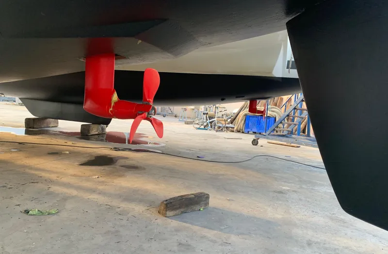 Jajapami Yacht Photos Pics Underneath view of 2017 Fountaine Pajot SABA 50 catamaran with red propeller.