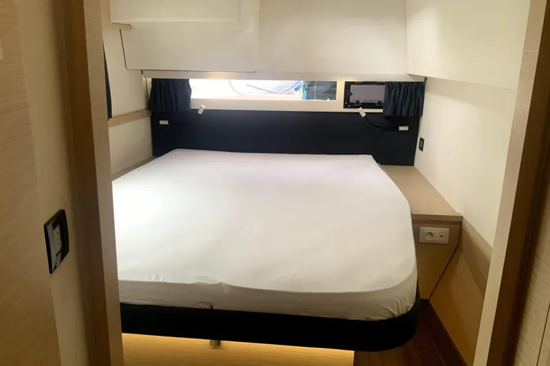 Jajapami Yacht Photos Pics Cabin interior of 2017 Fountaine Pajot SABA 50 catamaran with cozy bed and window view.