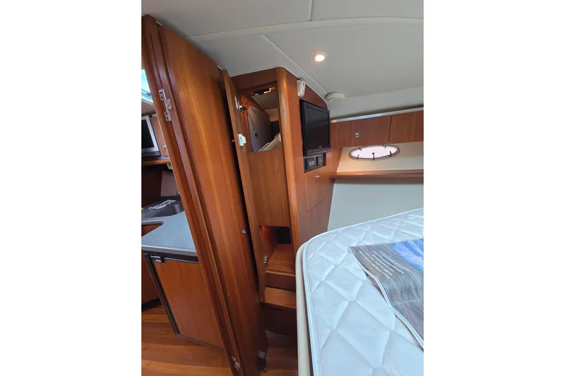  Yacht Photos Pics 2006 Tiara Yachts 3600 Open interior with wood cabinetry and cozy sleeping area.