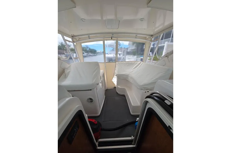  Yacht Photos Pics Interior view of 2006 Tiara Yachts 3600 Open, featuring covered seating and large windows.