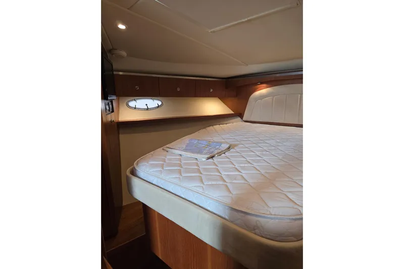  Yacht Photos Pics Luxurious cabin interior of 2006 Tiara Yachts 3600 Open with cozy bed and porthole.