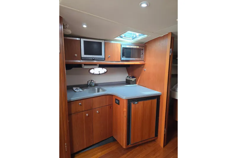 Yacht Photos Pics 2006 Tiara Yachts 3600 Open galley with wood cabinetry, sink, and appliances.