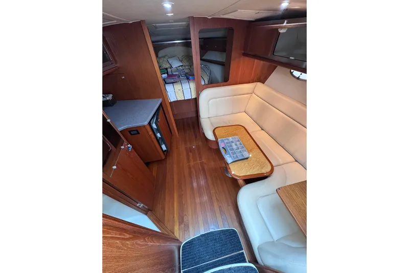  Yacht Photos Pics 2006 Tiara Yachts 3600 Open interior with wood flooring, beige seating, and compact kitchenette.