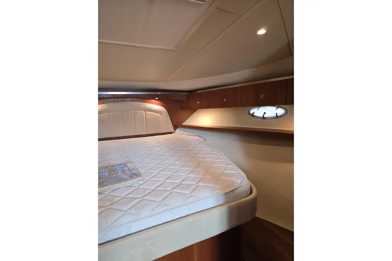  Yacht Photos Pics 2006 Tiara Yachts 3600 Open cabin interior with bed and porthole window.
