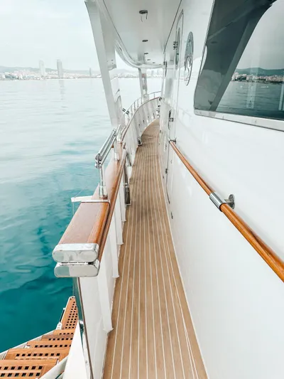 Laziza Yacht Photos Pics Side deck of 2004 Benetti Sail Division 82 RPH yacht with wooden railings.