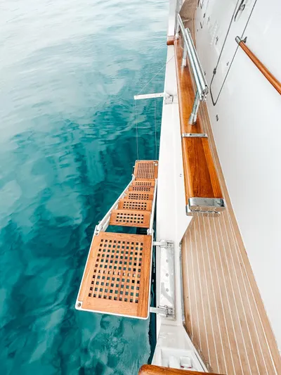 Laziza Yacht Photos Pics Luxury yacht Benetti Sail Division 82 RPH 2004 with wooden swim platform over clear water.