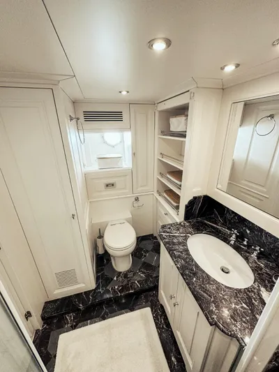 Laziza Yacht Photos Pics Luxurious bathroom on 2004 Benetti Sail Division 82 RPH yacht with marble countertop and elegant fixtures.