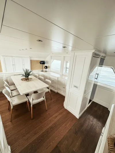 Laziza Yacht Photos Pics Luxurious dining area on 2004 Benetti Sail Division 82 RPH yacht with elegant white decor.