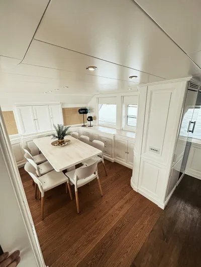 Laziza Yacht Photos Pics Elegant dining area on 2004 Benetti Sail Division 82 RPH yacht with modern decor.