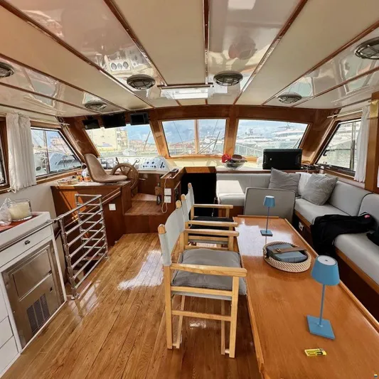  Yacht Photos Pics Luxurious interior of 1994 Viking Marin Caicco yacht with wooden furnishings and panoramic windows.