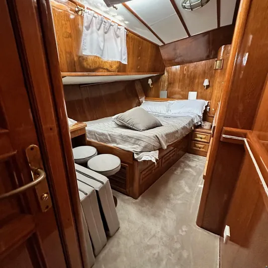  Yacht Photos Pics Cozy wooden cabin interior of 1994 Viking Marin Caicco yacht with bed and seating.