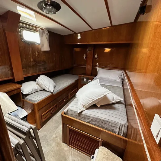  Yacht Photos Pics Cozy wooden cabin interior of 1994 Viking Marin Caicco with twin beds and nautical decor.