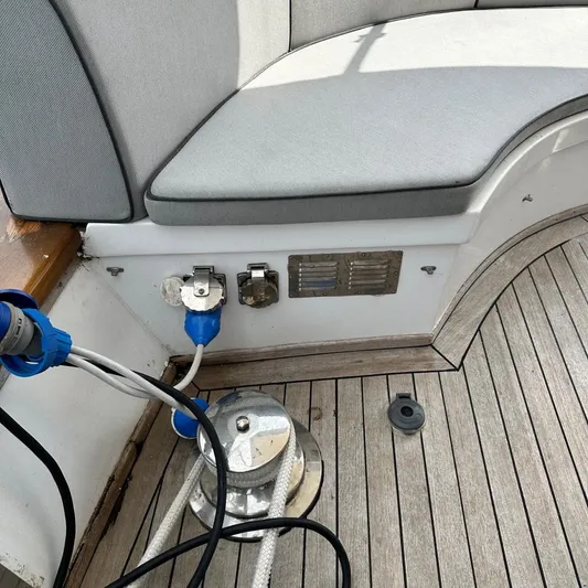  Yacht Photos Pics Viking Marin Caicco 1994 boat deck with seating, electrical connections, and wooden flooring.