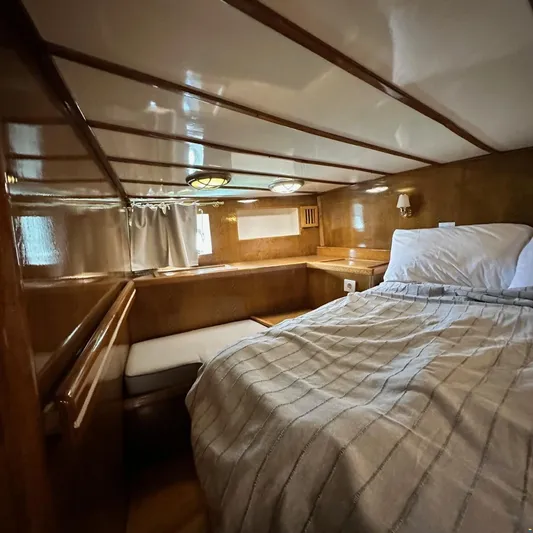  Yacht Photos Pics Cozy cabin interior of 1994 Viking Marin Caicco yacht with wooden finish and bed.