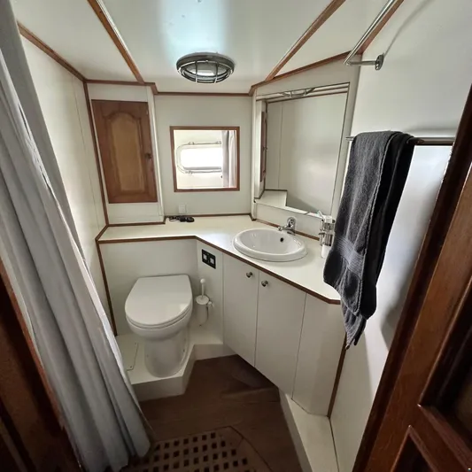  Yacht Photos Pics Bathroom interior of 1994 Viking Marin Caicco yacht, featuring sink, toilet, and towel rack.