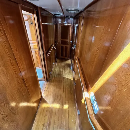  Yacht Photos Pics Wood-paneled hallway inside 1994 Viking Marin Caicco yacht, featuring polished surfaces and ambient lighting.