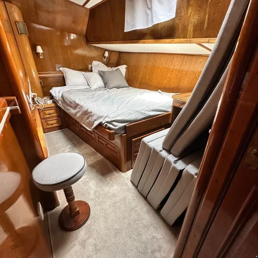  Yacht Photos Pics Cozy cabin interior of 1994 Viking Marin Caicco yacht with wooden furnishings and bed.