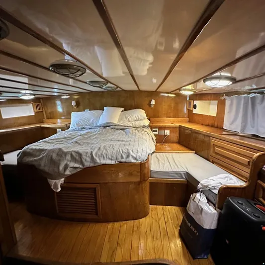  Yacht Photos Pics Cozy wooden cabin interior of 1994 Viking Marin Caicco yacht with bed and storage.