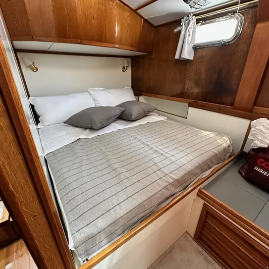  Yacht Photos Pics Cozy cabin interior of 1994 Viking Marin Caicco yacht with comfortable bed and wooden accents.