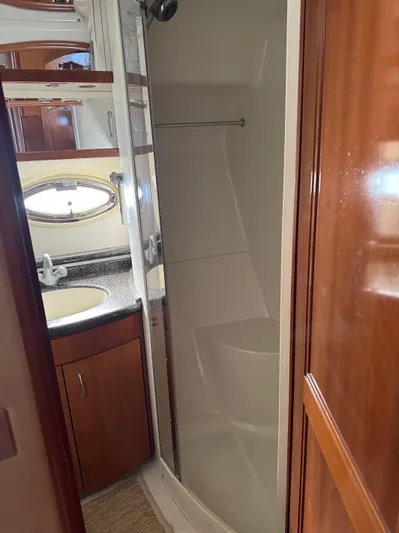  Yacht Photos Pics 2007 Carver 46 Voyager bathroom with shower, sink, and wooden cabinetry.
