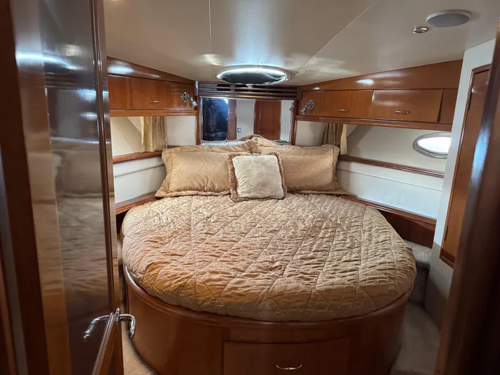  Yacht Photos Pics Luxurious bedroom interior of 2007 Carver 46 Voyager yacht with elegant wood finish.