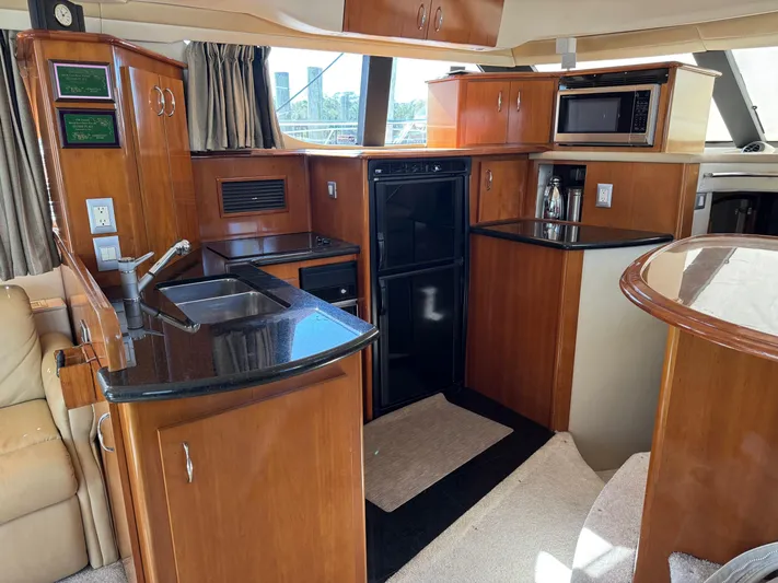  Yacht Photos Pics Interior of 2007 Carver 46 Voyager yacht kitchen with wood cabinetry and modern appliances.