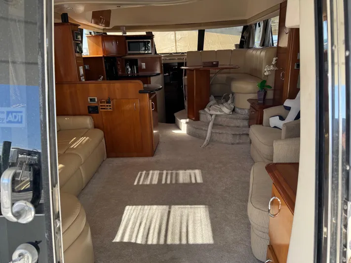  Yacht Photos Pics Interior of 2007 Carver 46 Voyager yacht, featuring luxurious seating and wood cabinetry.