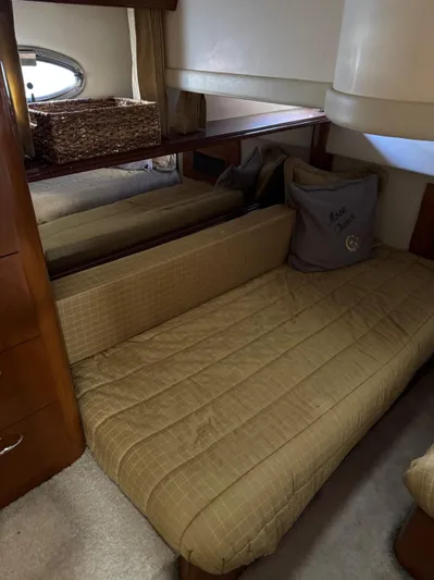  Yacht Photos Pics Interior cabin of 2007 Carver 46 Voyager yacht with beige bedding and wooden accents.
