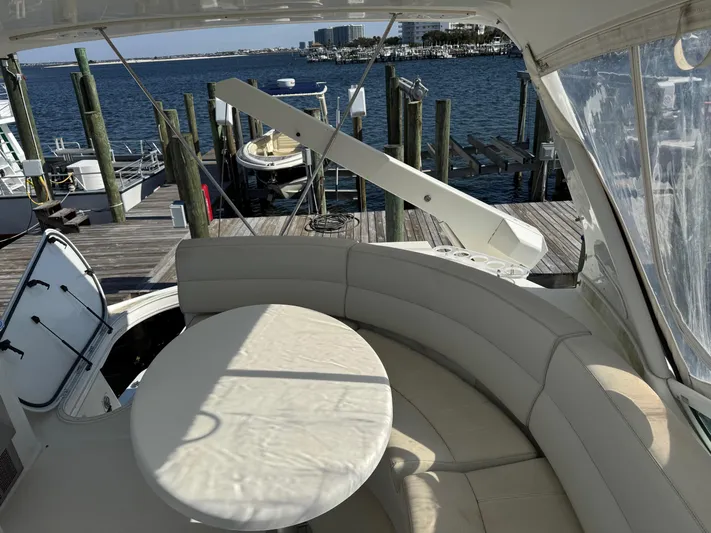  Yacht Photos Pics 2007 Carver 46 Voyager yacht interior with round seating and table, docked at marina.