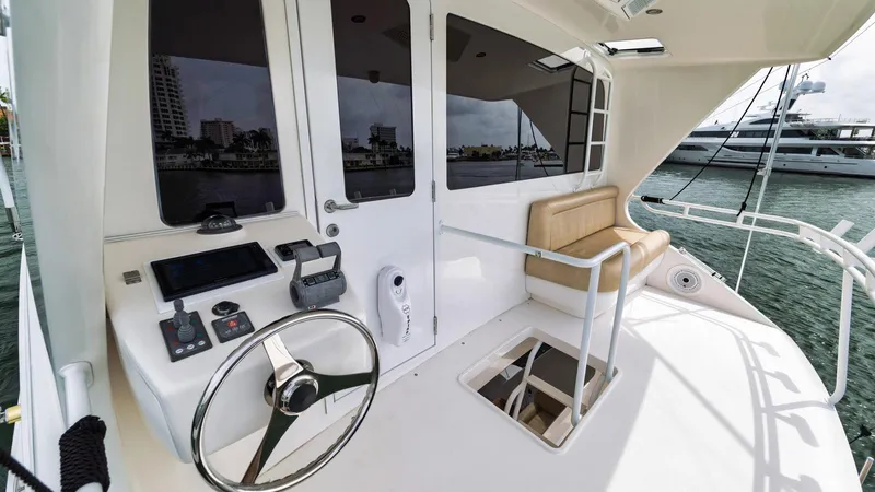 Nailed It Yacht Photos Pics 2008 Viking 74EB yacht helm with steering wheel, controls, and seating area.