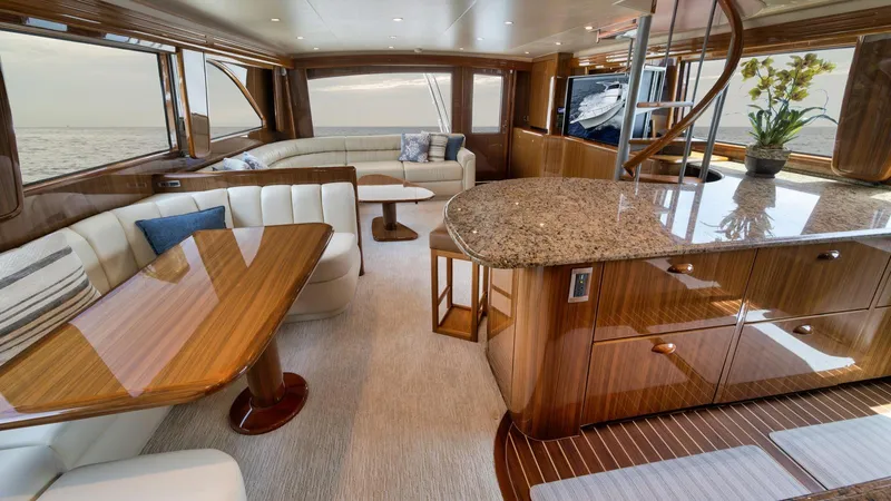 Nailed It Yacht Photos Pics Luxurious interior of 2008 Viking 74EB yacht with elegant wood finishes and ocean view.