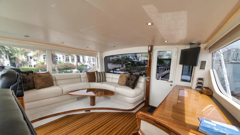 Nailed It Yacht Photos Pics Luxurious interior of 2008 Viking 74EB yacht with elegant seating and wooden accents.