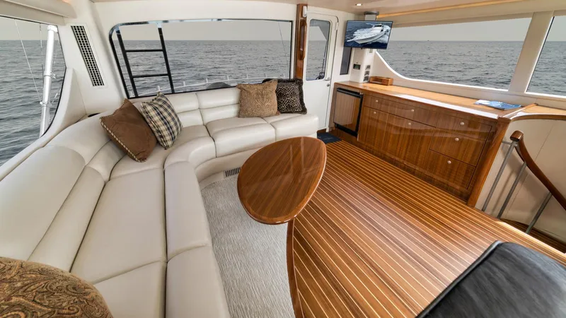 Nailed It Yacht Photos Pics Luxurious interior of 2008 Viking 74EB yacht with elegant seating and ocean view.
